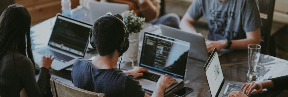 group of people using laptop computer