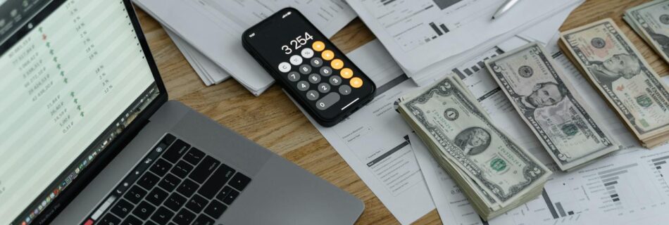 Banknotes and Calculator on Table